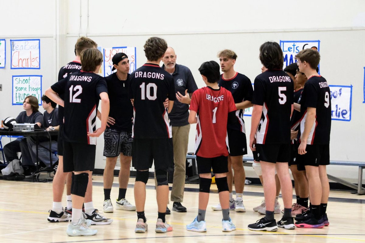 On Feb. 25, 2025, Foothill Technology (Foothill Tech) boys volleyball faced off against Cate School (Cate). Taking place at Cabrillo Middle School, Foothill Tech's own terrain, the match began at 6 p.m. Unfortunately, this second home game of the season ended in a 3-1 loss. Foothill Tech secured the first set, yet fell to Cate in the last three. In the image above, the team gathers in a tight huddle during a timeout, strategizing for the following sets. Coach Dave Benedik urges the team to communicate more efficiently,  as many lost points were attributed to a lack of communication on passes and set balls. The team listens intently, hoping to garner more points as they return to their positions on the court.