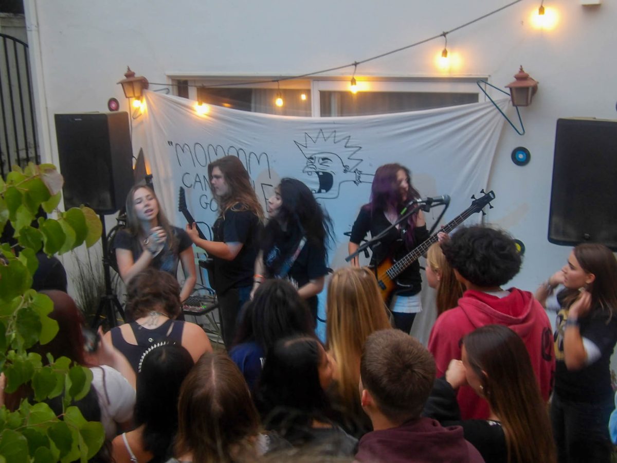 The newly formed cover band Hear Her Cries performs their version of "Circles" by Pierce the Veil. Audience members and fans of the song cheer and sing in unison, making it a crowd favorite of the night.