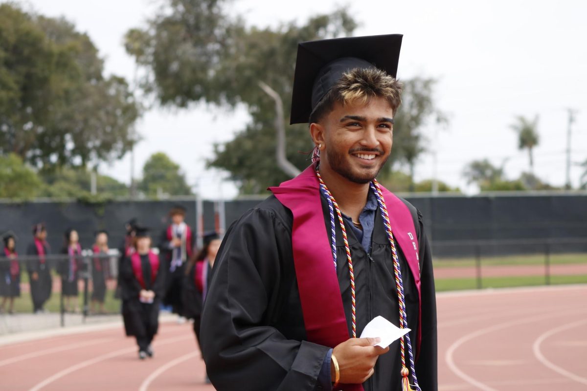 Ansh Joshi '26 smiles brightly at the audience as he walks to the stage. Joshi played tennis during his time at Foothill Technology High School (Foothill Tech). His smile reflects the senior class's excitement for the next step in their lives.