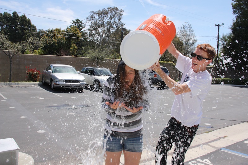 Multimedia editor Jackson Tovar dumps a cooler of water on Editor-in-Chief Anaika Miller in honor of receiving the Pacemaker award. Photo illustration credit: Aysen Tan/The Foothill Dragon Press