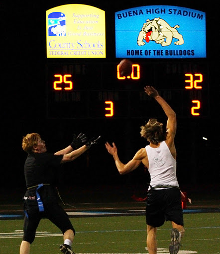 Seniors Greg Oyan and Xander Rockney-Finger reach for the ball in the final play of the first half of the senior class flag football game. Credit: Aysen Tan/The Foothill Dragon Press