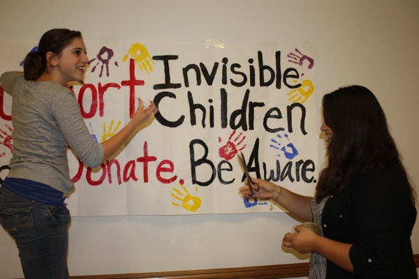 Seniors Karen Fox and Molly Roberts volunteer with the rest of the Invisble Children club to raise awareness about child soldiers at Spirito Hall on Thursday, December 9th. Photo Credit: Lauren Parrino/ The Foothill Dragon Press.