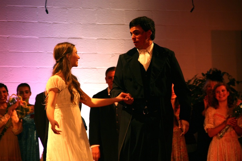 Foothill alumnus David White and PTYA member Ayla DuMont take their final bow for the production of "Pride and Prejudice" at the Poinsettia Pavilion Friday night. Credit: Caitlin Trude/The Foothill Dragon Press