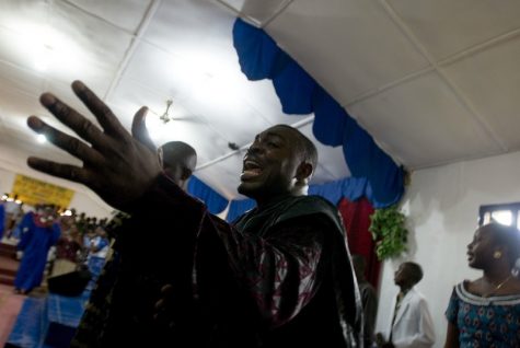 Evangelist Joshua Milton Blahyi preaches in a slum on the outskirts of Monrovia, Liberia. Credit: Ryan Lobo, used with permission of Daniele Anastasion and Eric Strauss.
