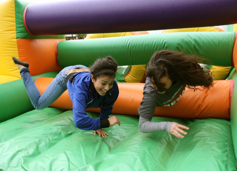 Sophomores Jesa Bryant-Simental (left) and Holly Guzman (right) have fun on an inflatable maze during Friday's Renaissance Rally. Credit: Felicia Perez/The Foothill Dragon Press