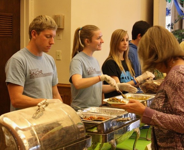 Members of Foothill for Africa serve traditional Sierra Leonean food at the club's last fundraiser yesterday. Credit: Rachel Crane/The Foothill Dragon Press.