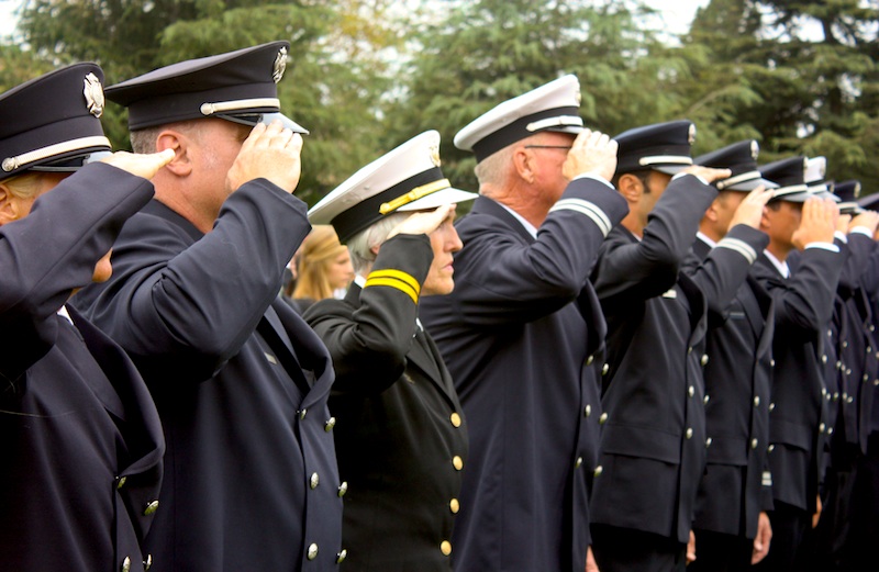 Police officers salute in remembrance of those who lost their lives on September 11, 2001. Credit: Rachel Crane/The Foothill Dragon Press.