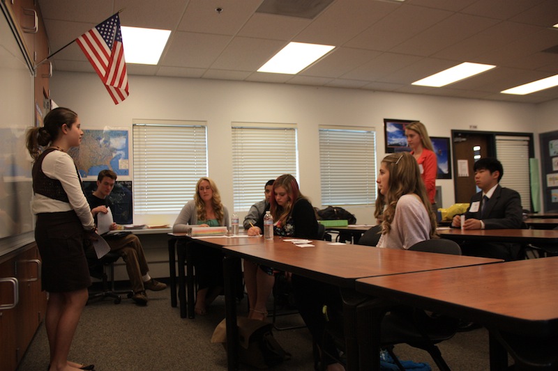 Freshman Patricia McCoy (left) answers a question from Daisy Myring (far right) about why food companies hide the ingredients in their products at Mondays Ninth Grade Project presentation. Credit: Felicia Perez/The Foothill Dragon Press