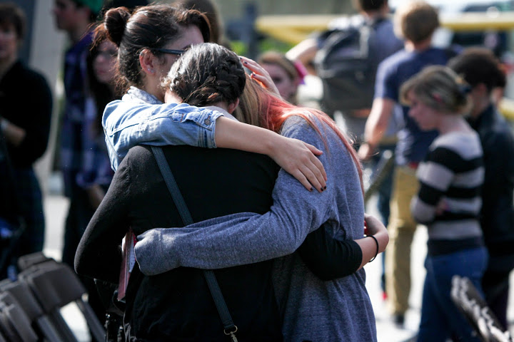 Seniors Desiree Sehati, Sydney Gustafson, and Sophia Horigan hug after watching the crash simulation. Credit: Bethany Fankhauser/The Foothill Dragon Press