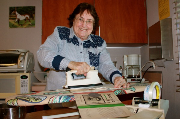 Volunteer Ellie Bollinger irons book covers for Foothills library. Credit: Rachel Crane/The Foothill Dragon Press.