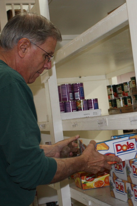 Frank Maggio, a volunteer for Project Understanding, helps to organize canned goods on the shelves of the Food Pantry. Credit: Veronica Mellring/The Foothill Dragon Press