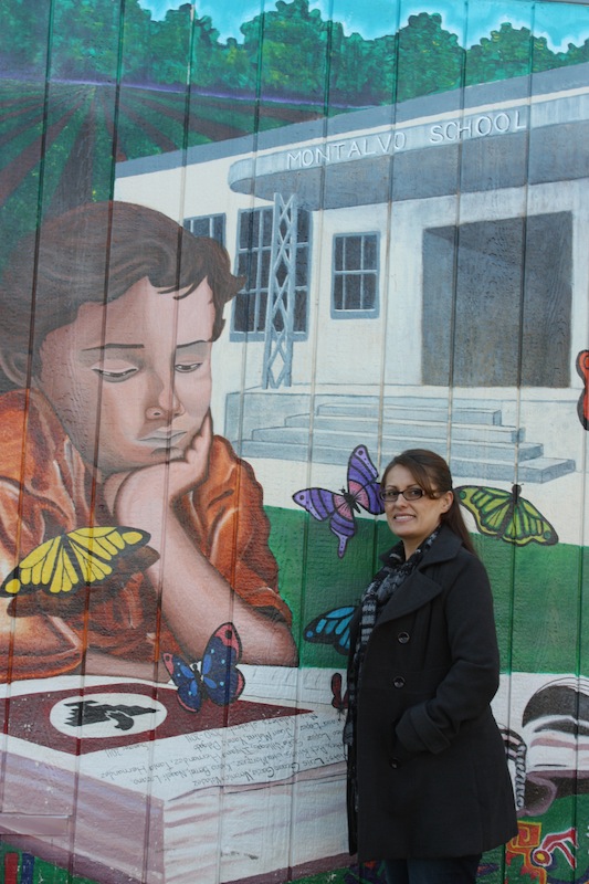 Local artist Veronica Valadez stands in front of a mural she painted with the help of others at Montalvo Elementary School. Credit: Veronica Mellring/The Foothill Dragon Press